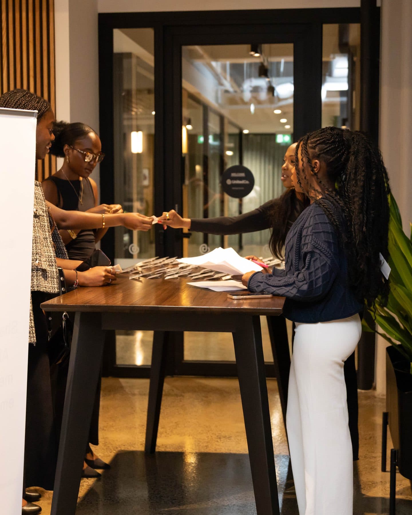 Guests collecting their name tags at the welcome desk at UNSCRUBBED.