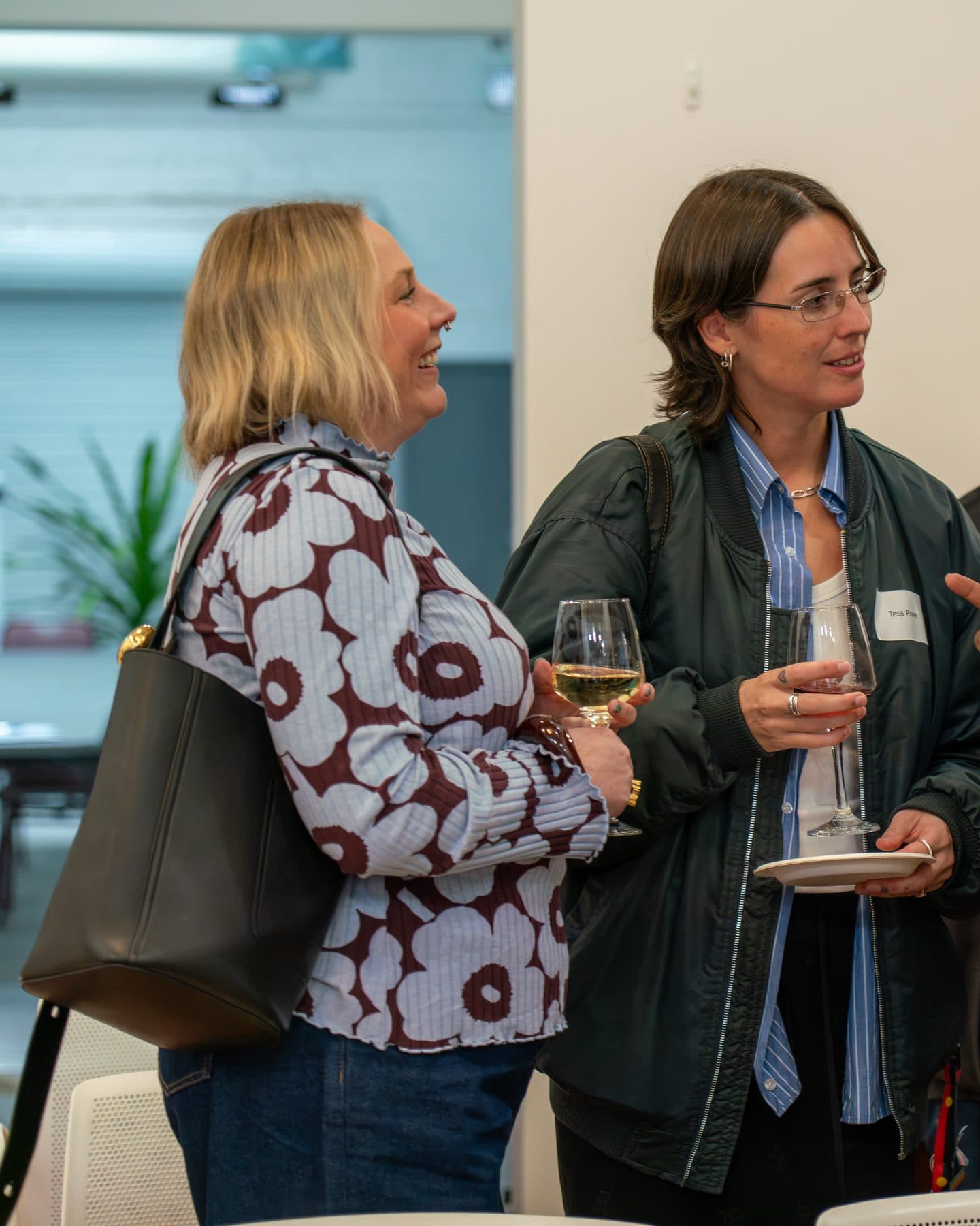 Guests talking over glasses of wine at Inner North Community Foundation's event.