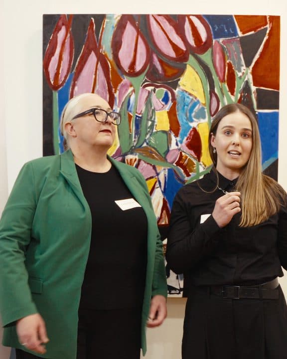 INCF: Pathways to Employment: two speakers in front of a painting at Inner North Community Foundation's event